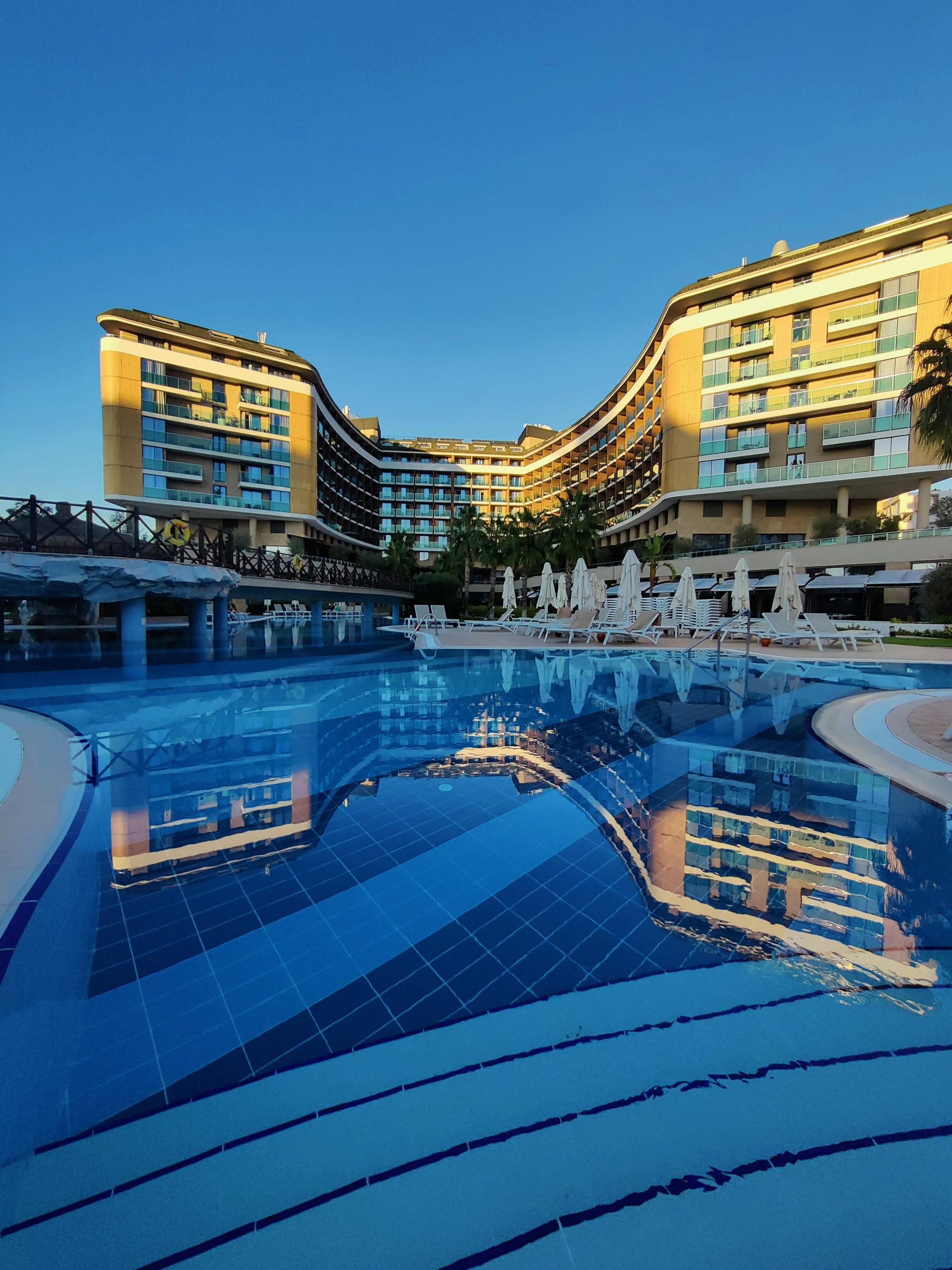 Stunning luxury resort in Antalya, Turkey, featuring a beautiful infinity pool at sunset.